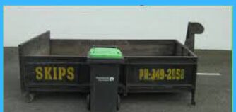 Open black 2 cubic metre mini skip bin with yellow SKIPS lettering hired out by Christchurch Skip Hire